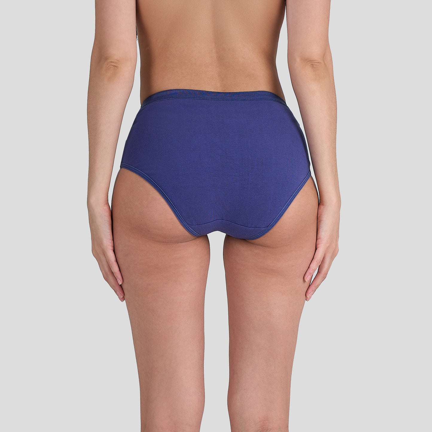 Person wearing a Dice blue high-waisted bikini bottom on a plain background