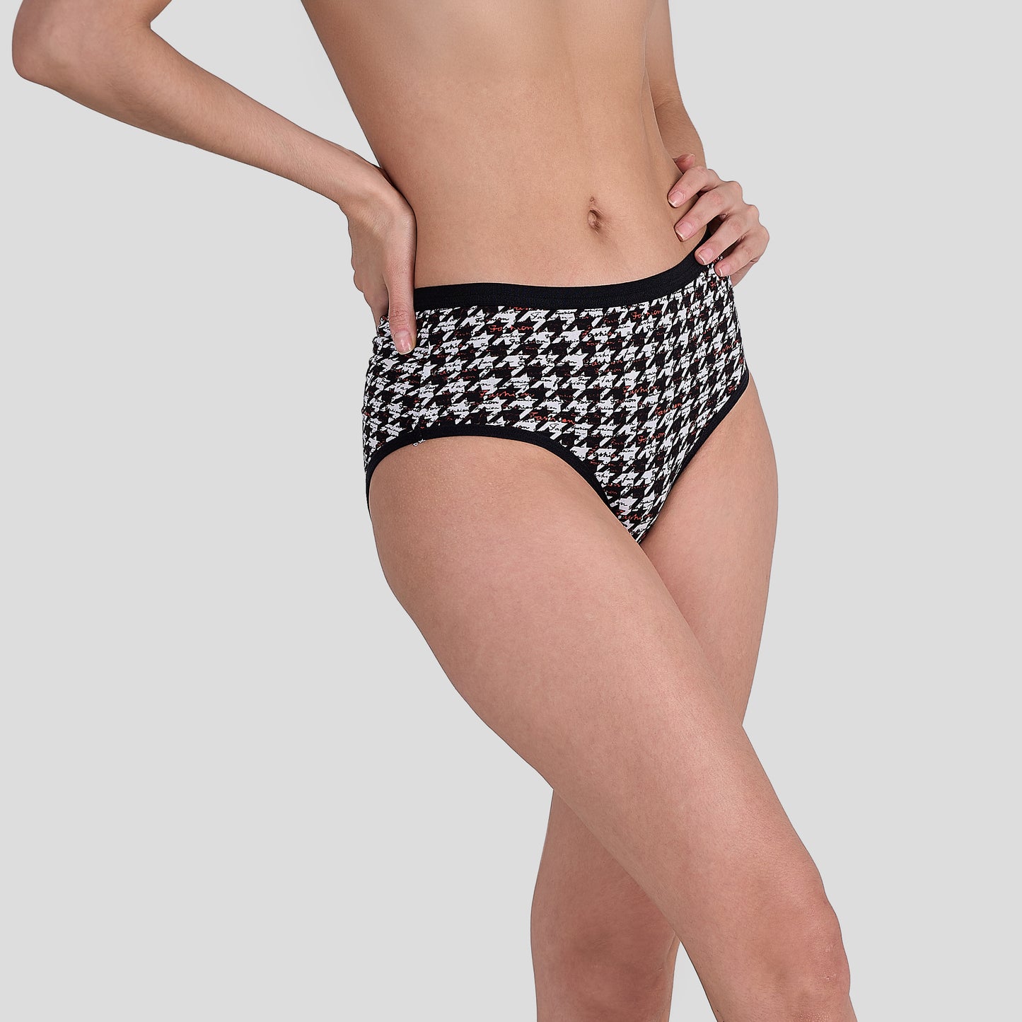 Person wearing a Dice black and white houndstooth patterned underwear on a plain background
