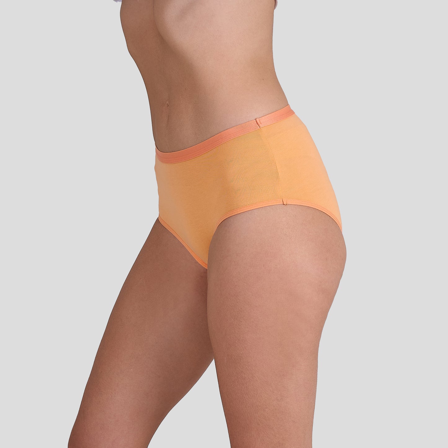 Dice Orange underwear worn by a person on a light gray background