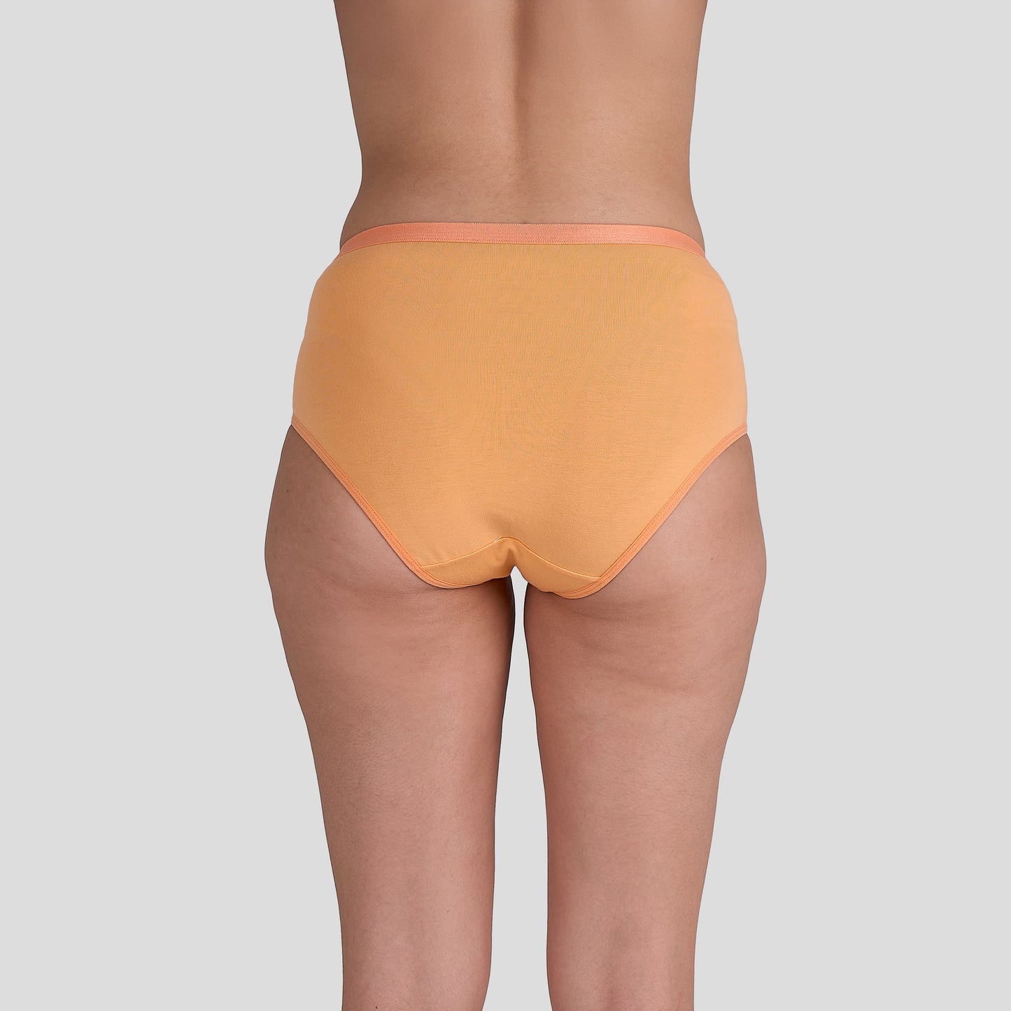 Dice Orange underwear worn by a person on a light gray background