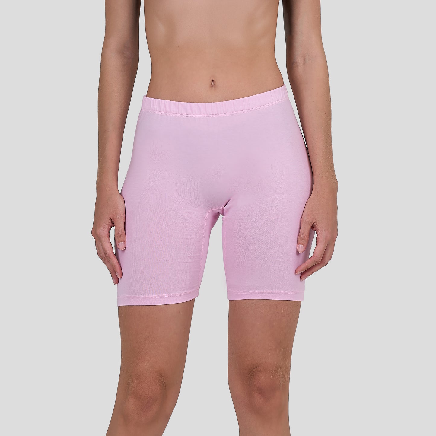 Person wearing a Dice light pink shorts on a plain background