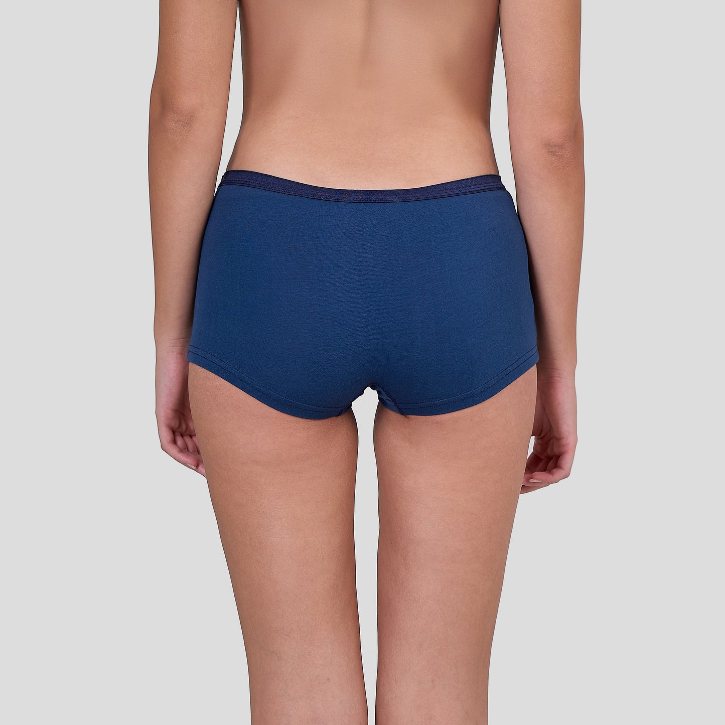 Person wearing a Dice navy blue underwear on a light gray background