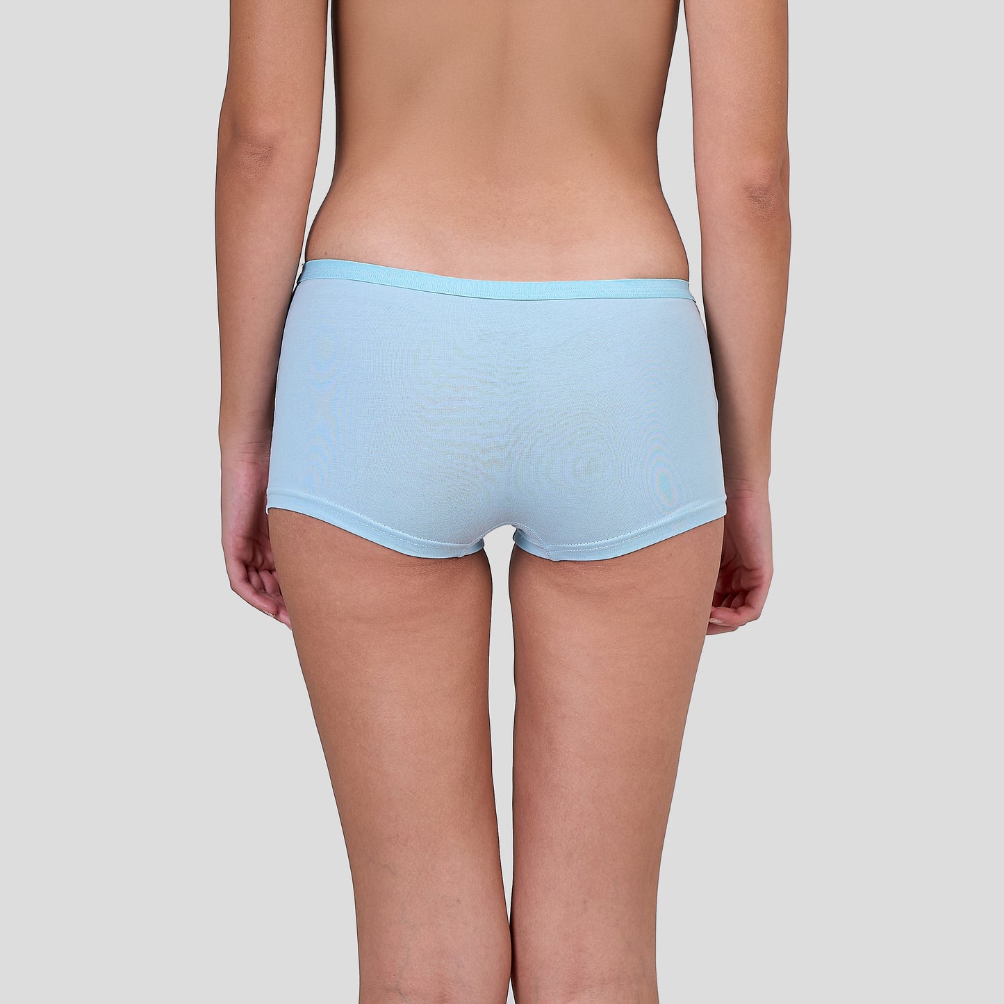 Dice Light blue underwear worn by a person on a plain background