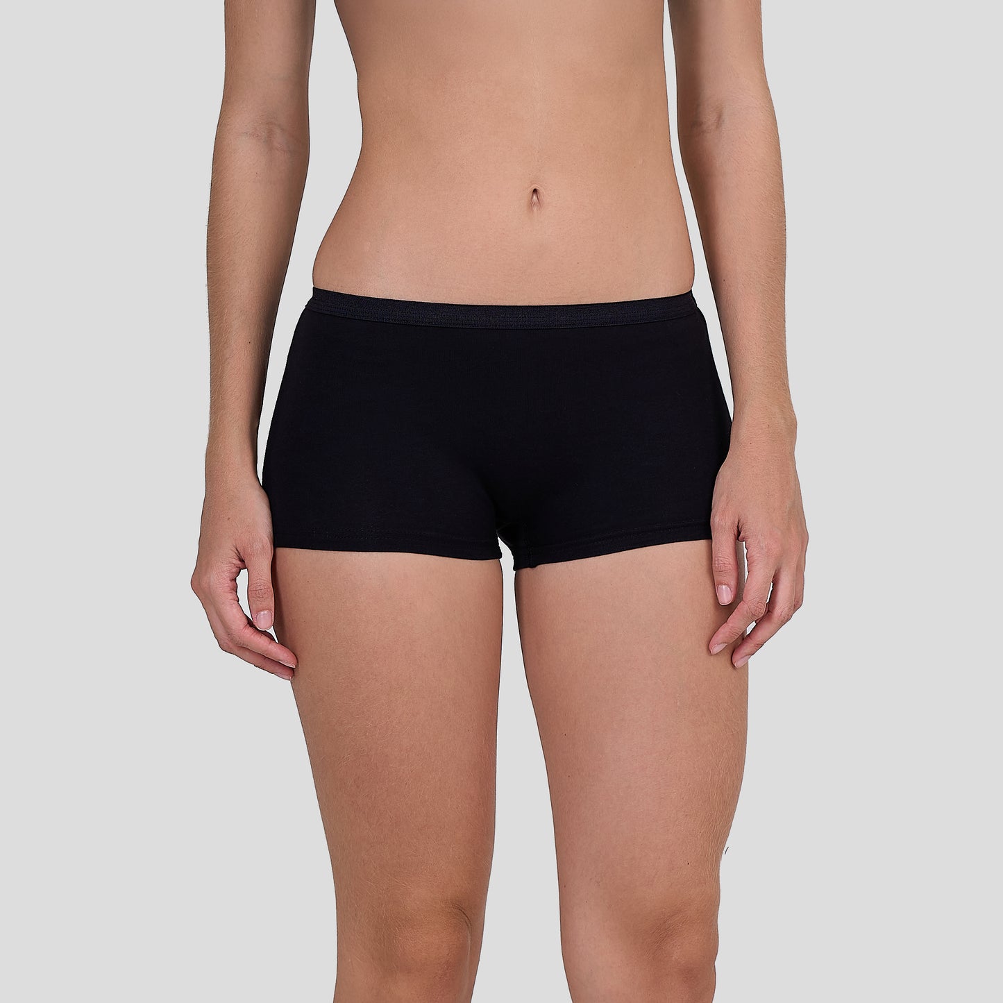 Person wearing a Dice black underwear on a plain background