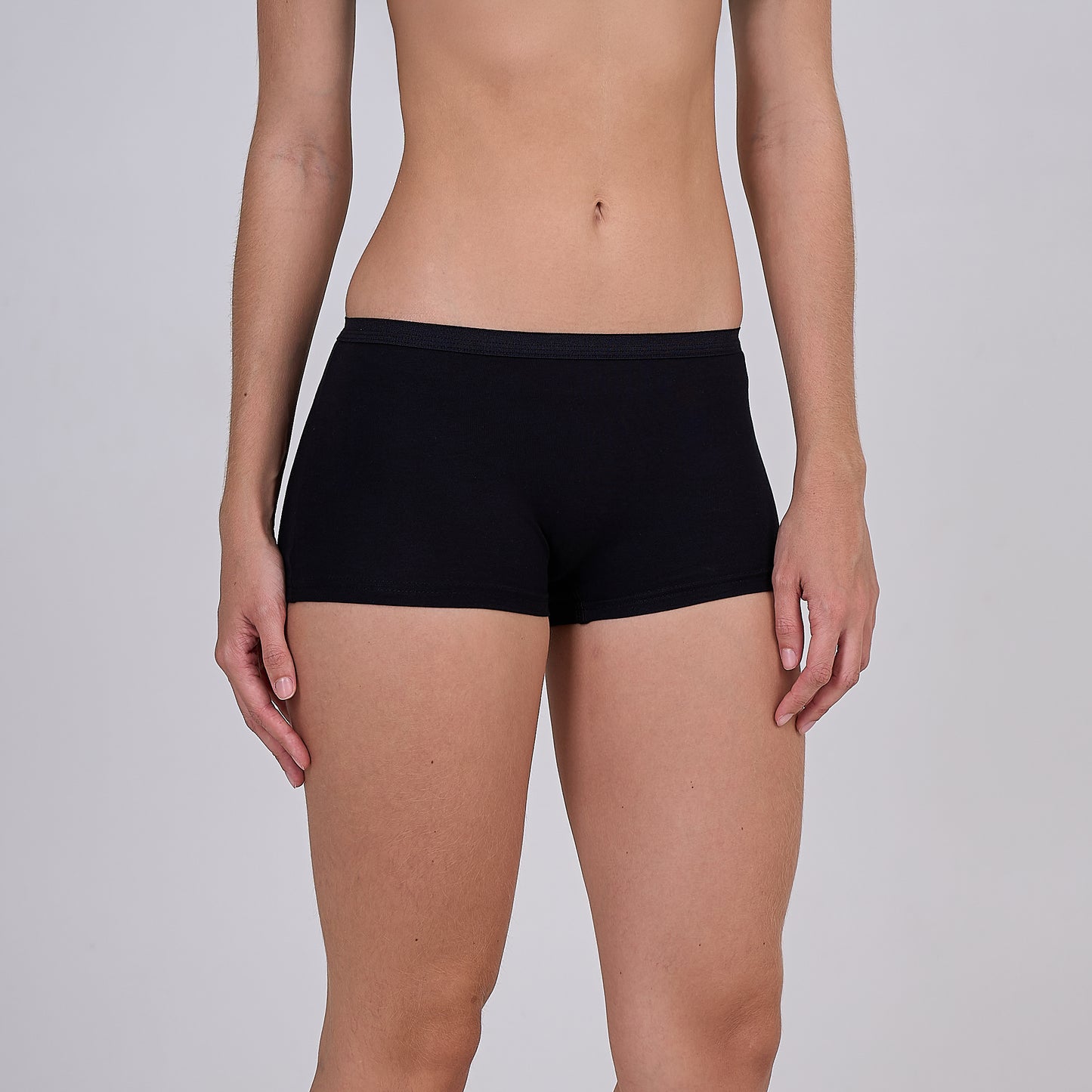 Person wearing a Dice black underwear on a plain background