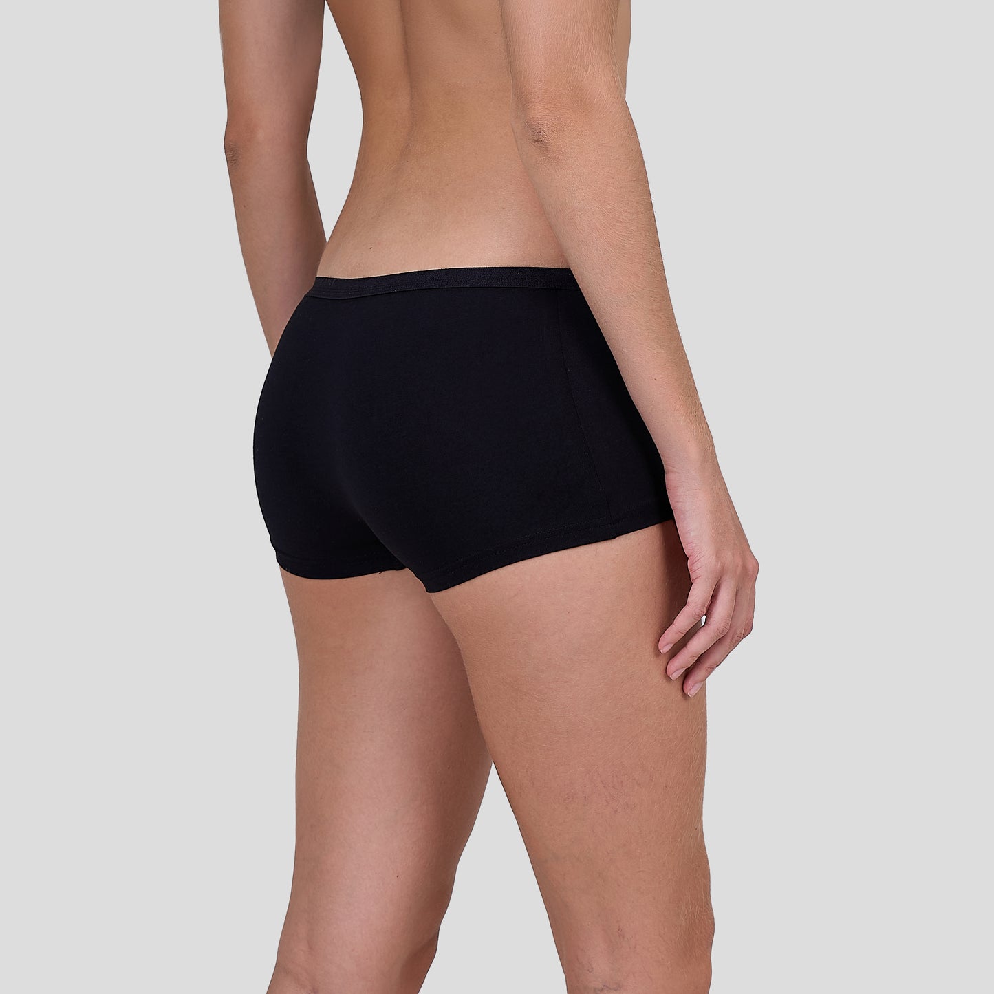 Person wearing a Dice black underwear on a plain background