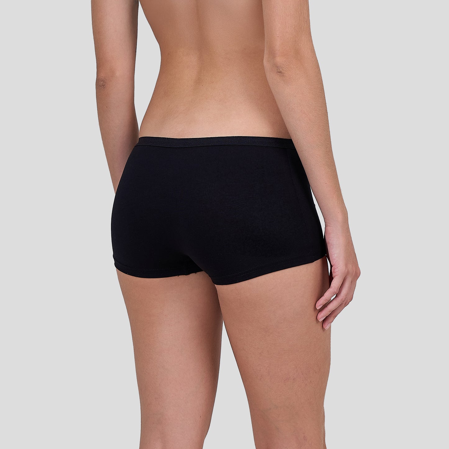 Person wearing a Dice black underwear on a plain background