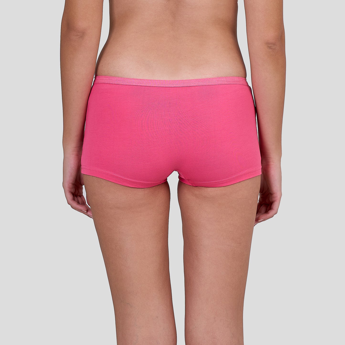 Person wearing a Dice bright pink underwear on a plain background