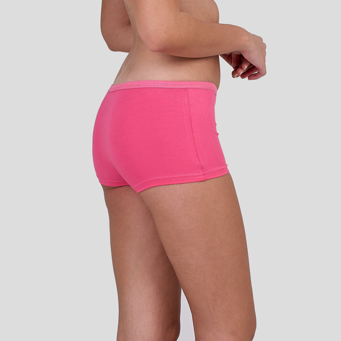 Person wearing a Dice bright pink underwear on a plain background