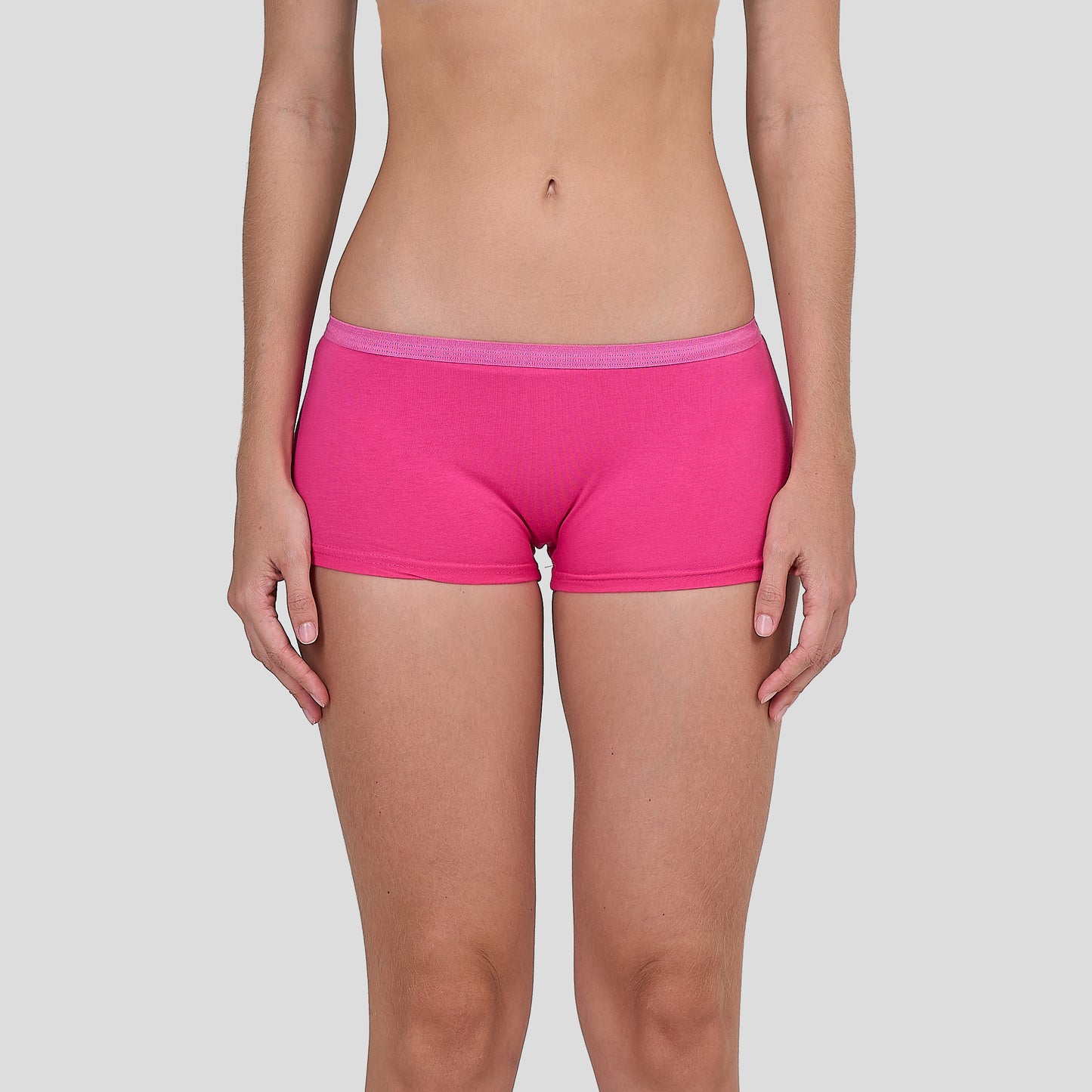 Person wearing a Dice bright pink underwear on a plain background