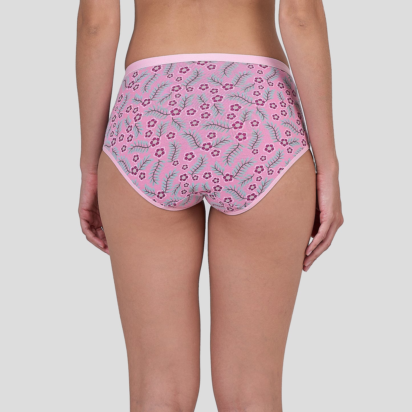 Dice Pink floral-patterned underwear worn by a person on a plain background
