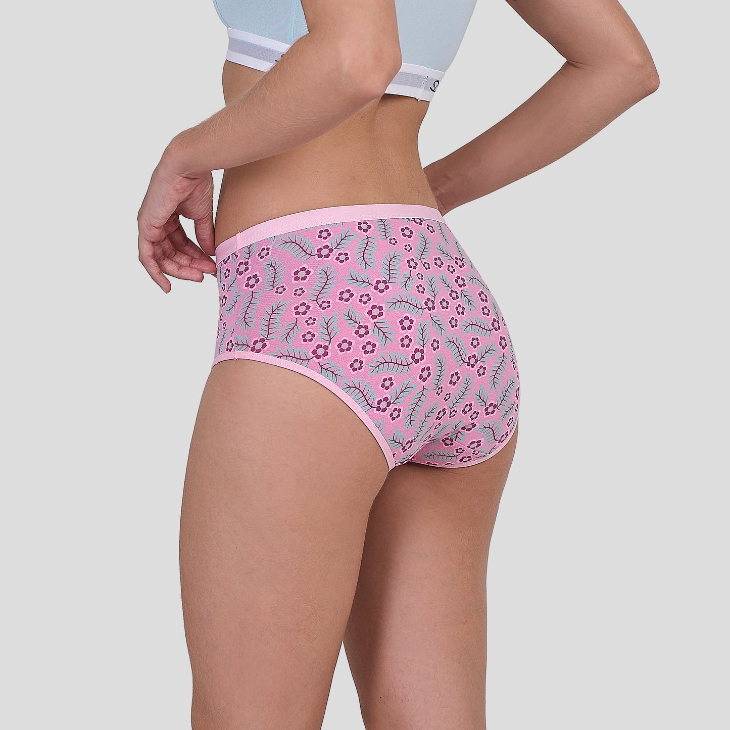 Person wearing a Dice pink floral underwear on a plain background