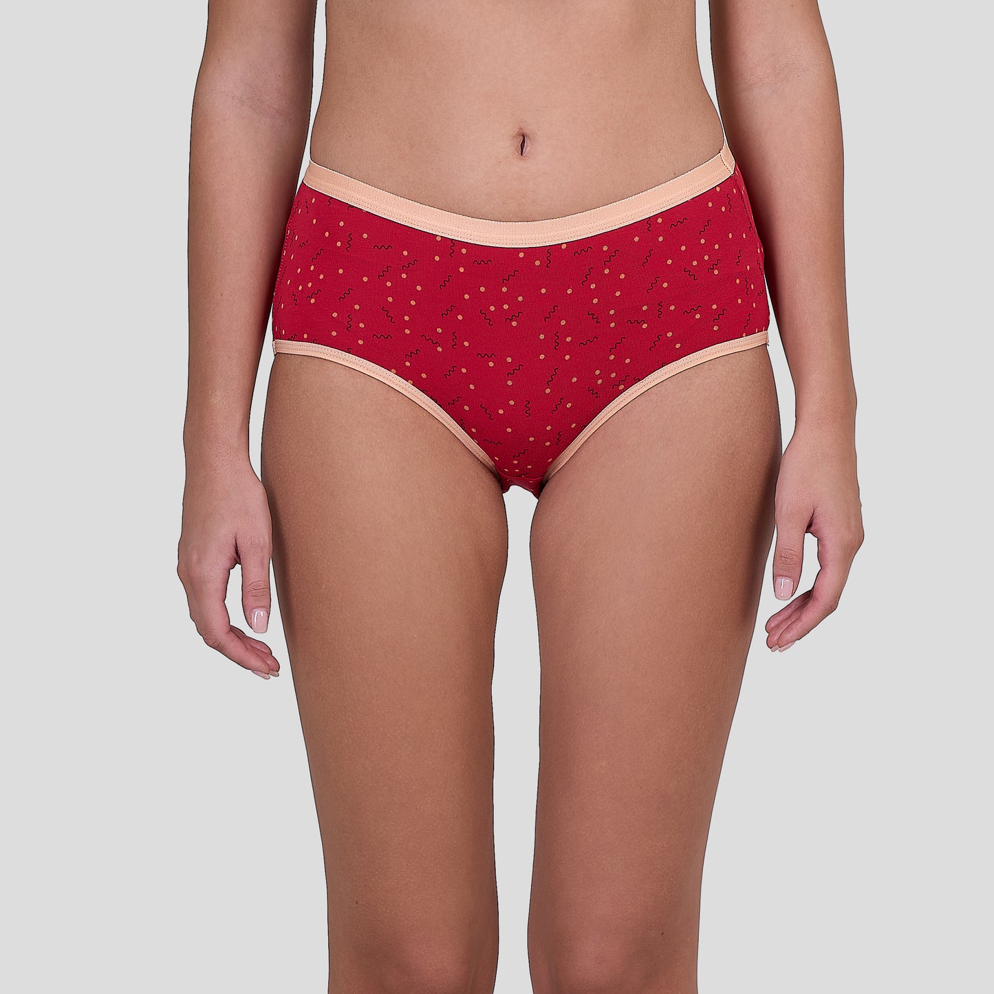 Dice Red patterned underwear worn by a person on a light gray background