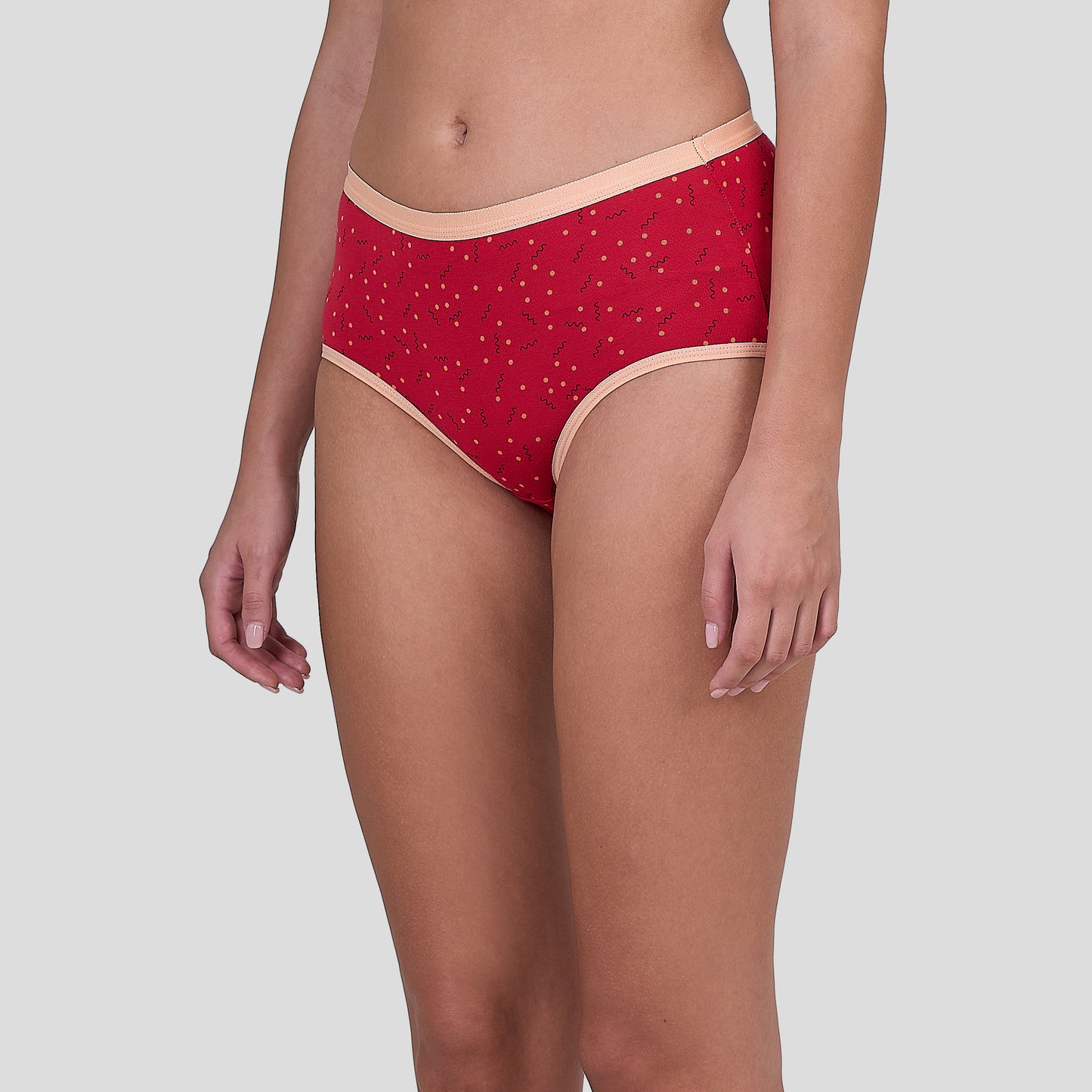 Dice Red patterned underwear worn by a person on a light gray background