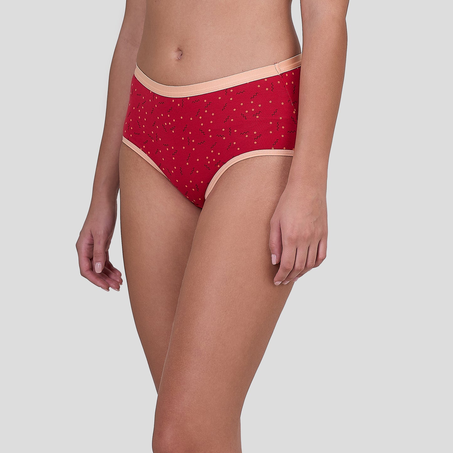 Dice Red patterned underwear worn by a person on a gray background