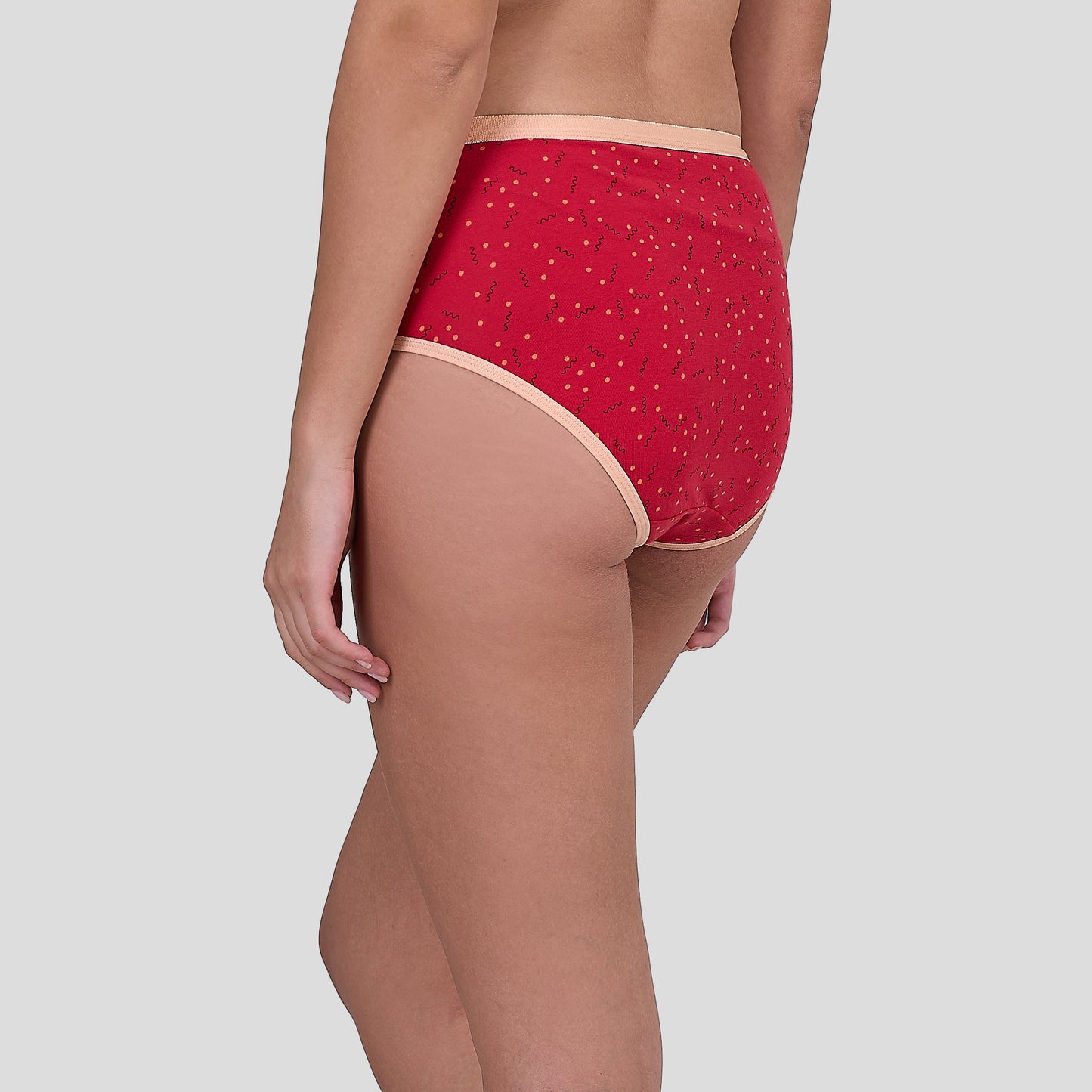 Dice Red patterned underwear worn by a person on a light gray background
