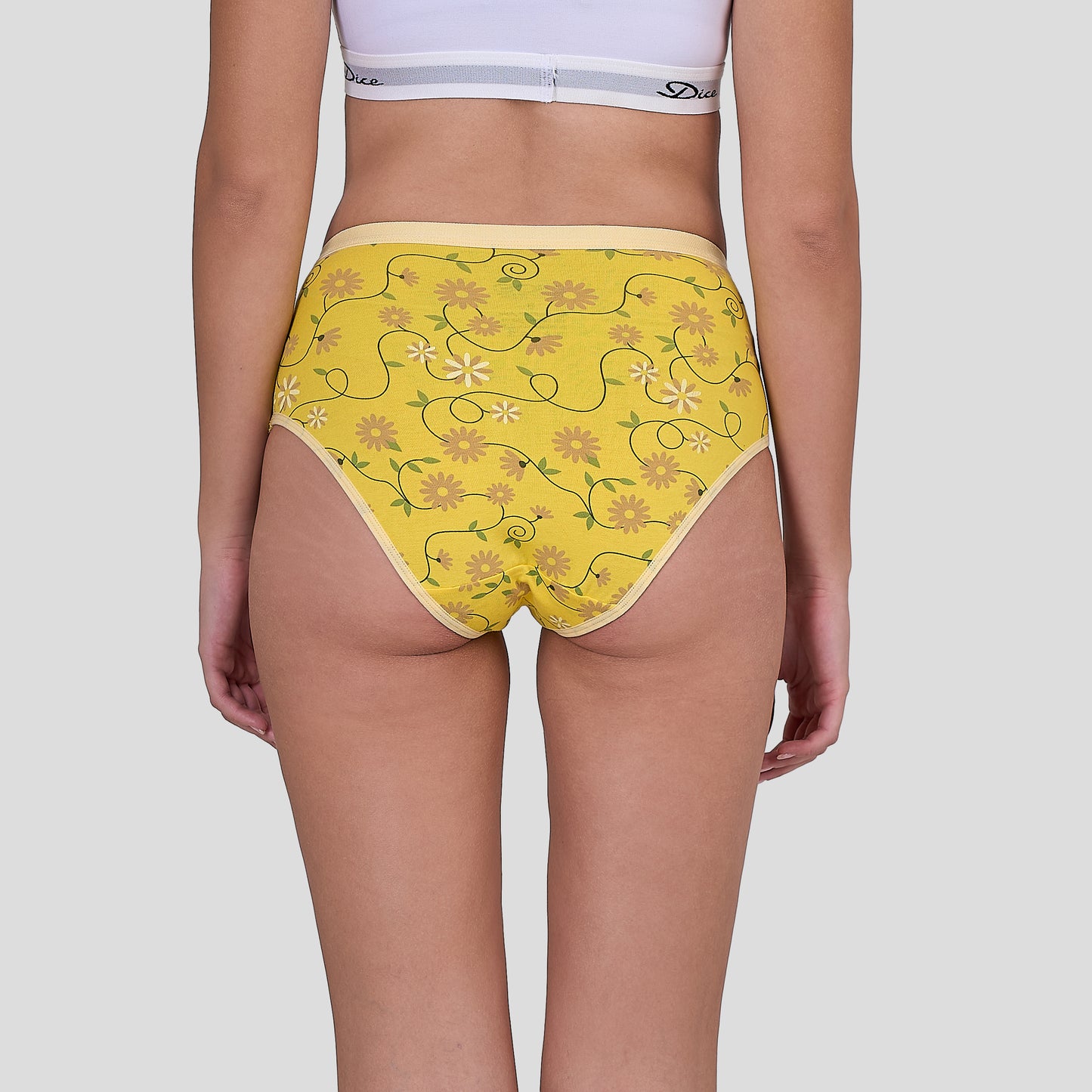 Dice Yellow floral-patterned underwear worn by a person on a plain background