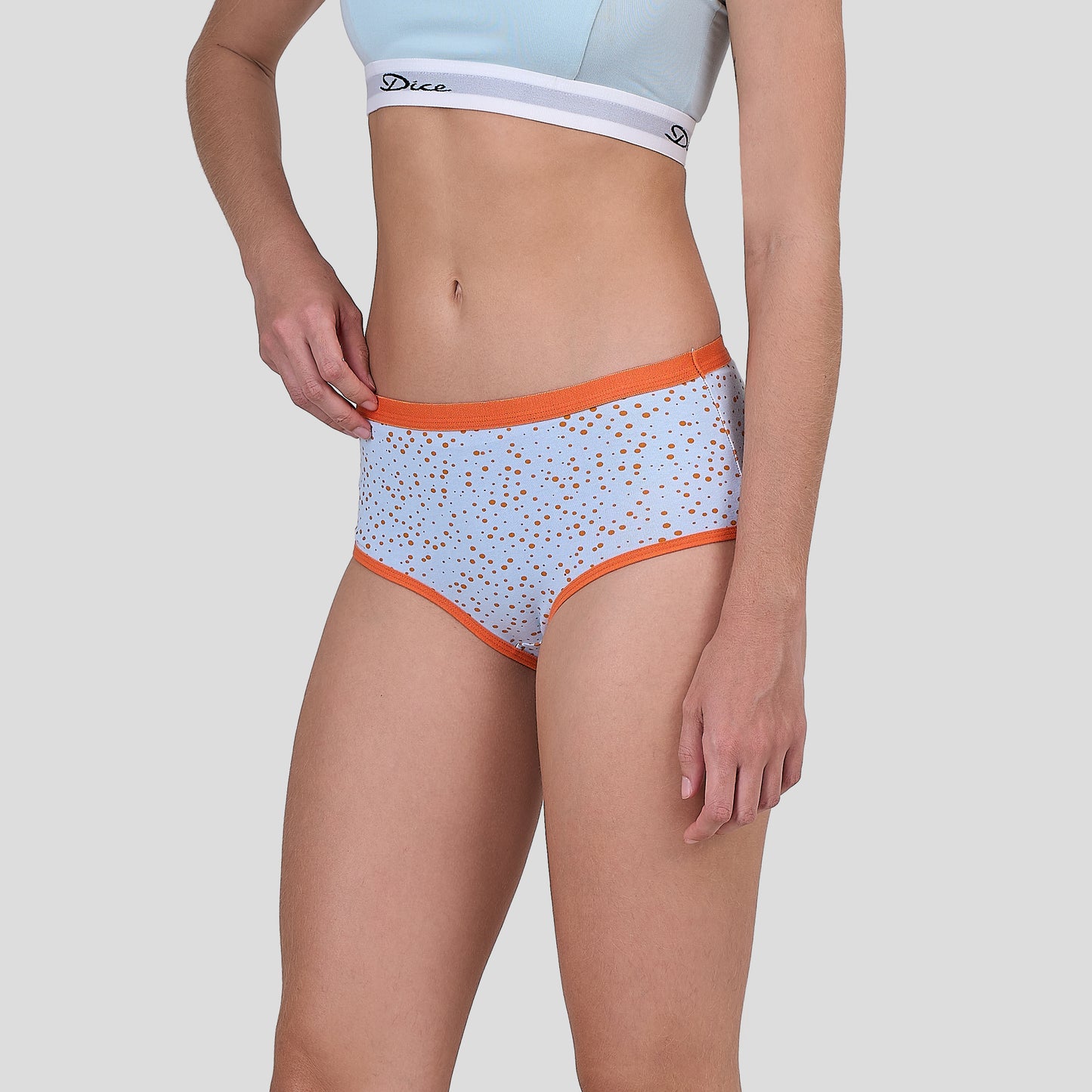 Dice Light blue underwear with orange trim worn by a person on a white background