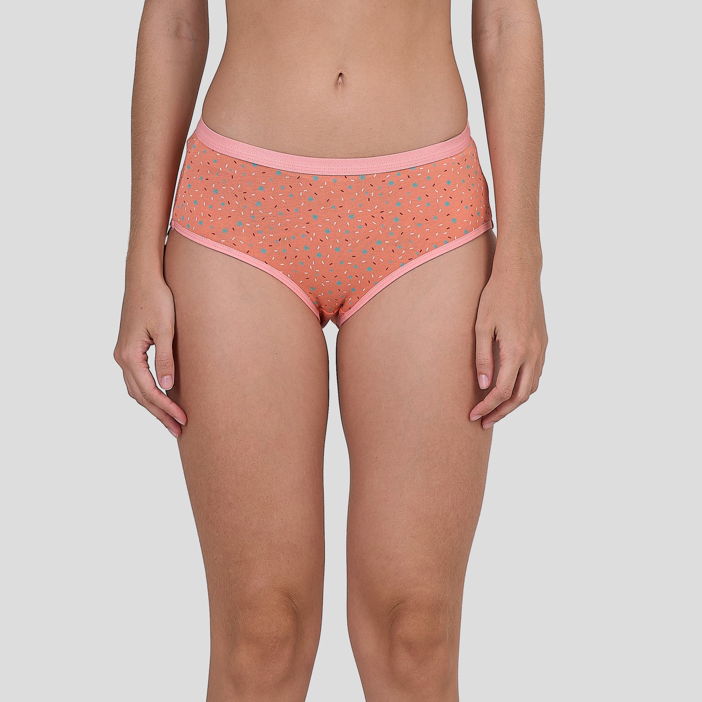 Person wearing a Dice coral patterned underwear on a plain background