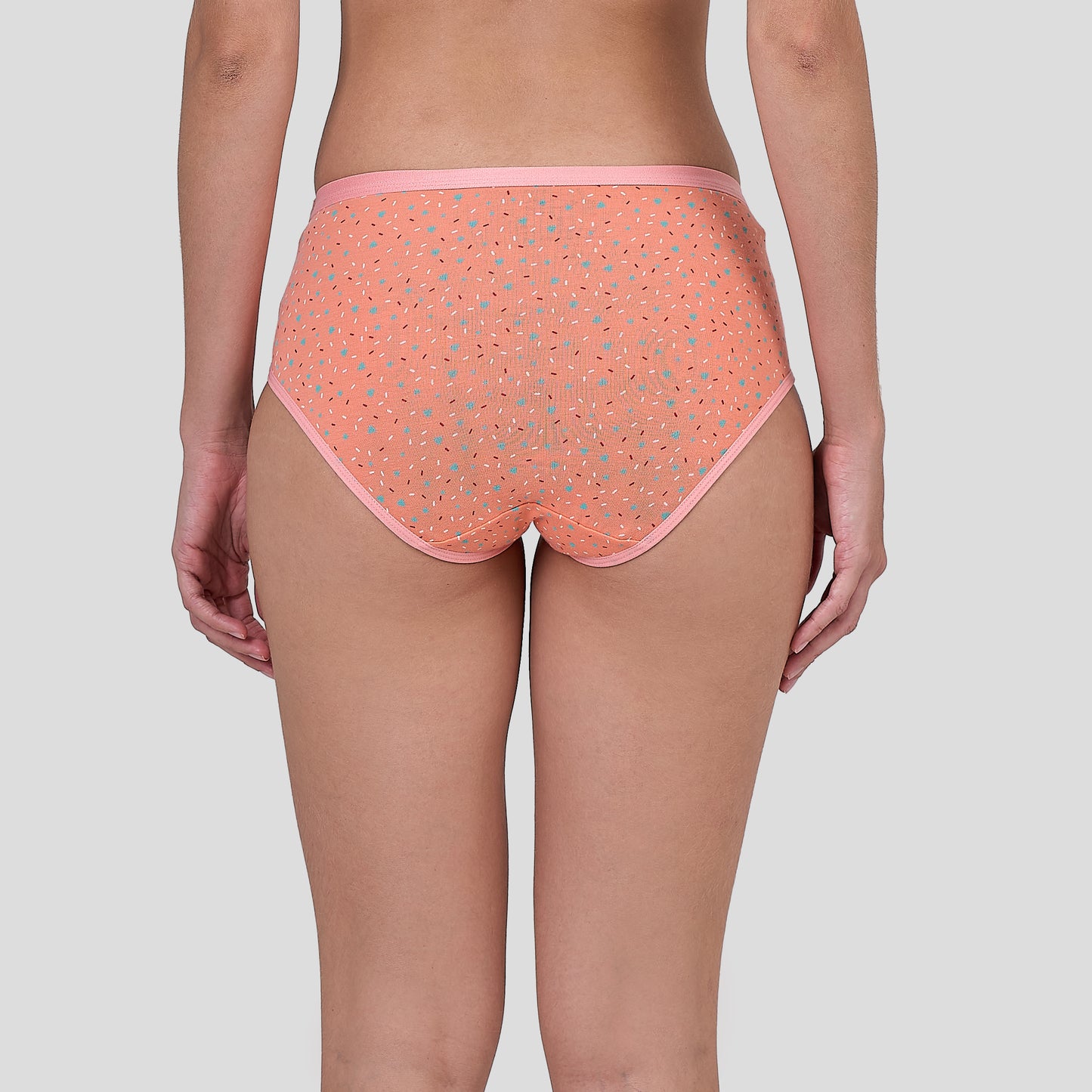 Person wearing a Dice patterned pink underwear on a plain background