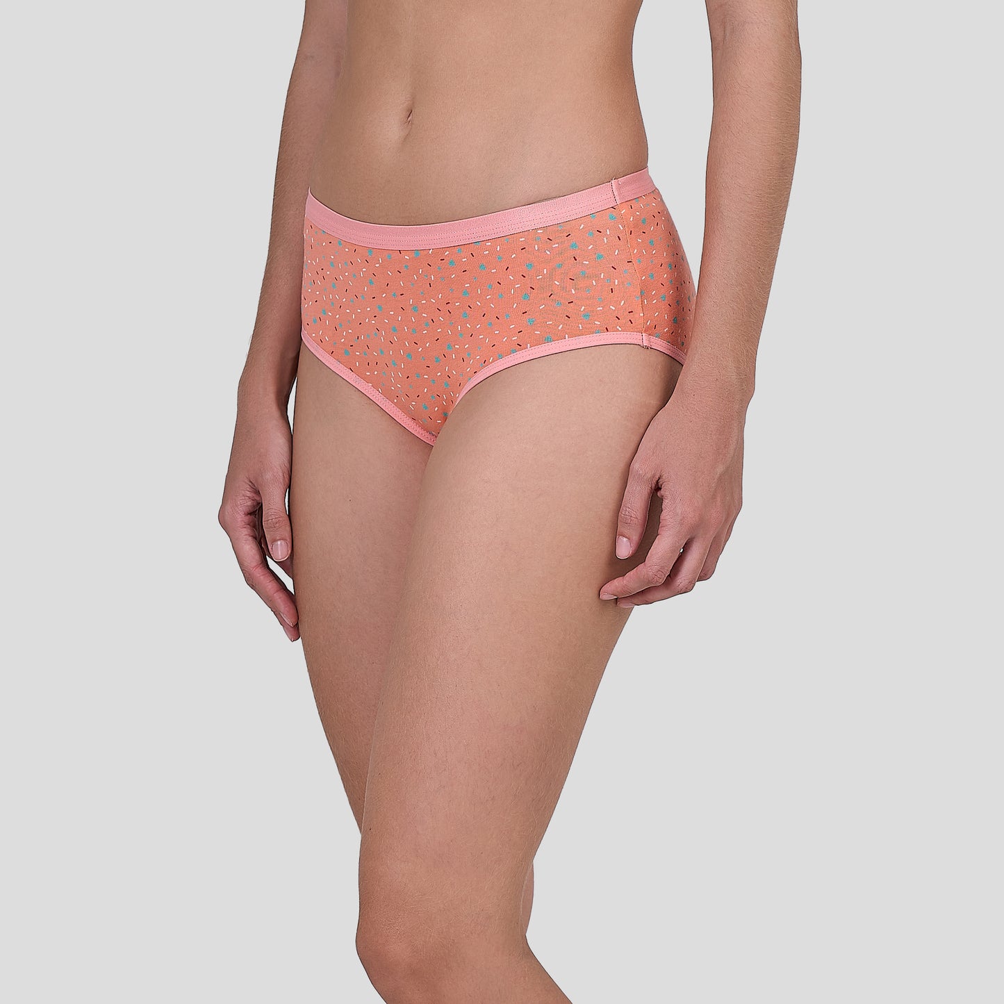 Person wearing a Dice patterned orange underwear on a plain background