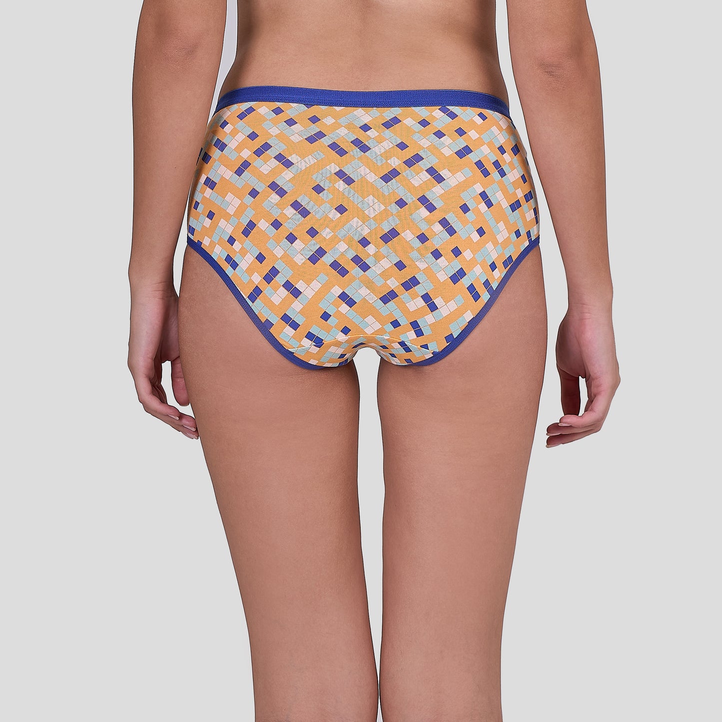 Dice Patterned underwear worn by a person on a plain background