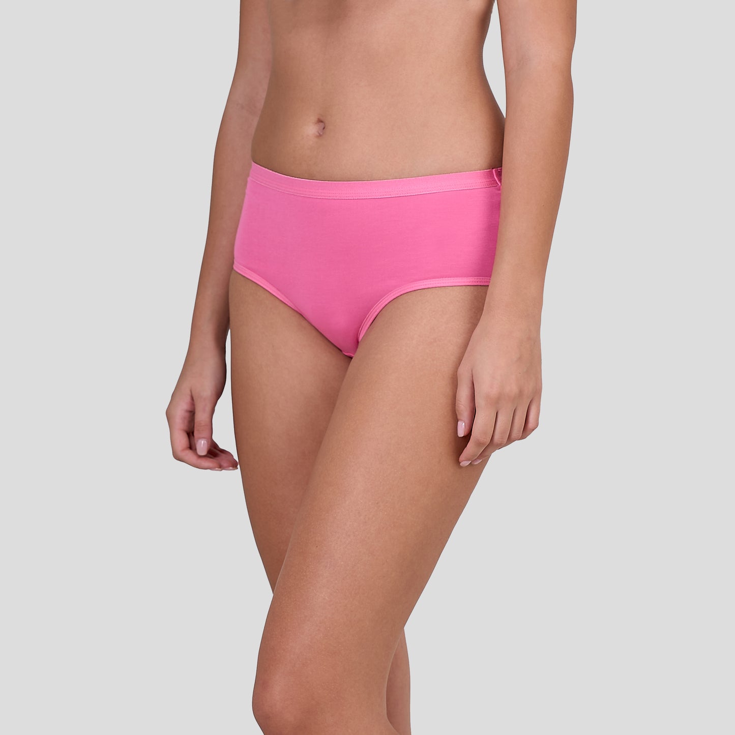 Person wearing Dice bright pink high-waisted bikini bottoms on a light gray background