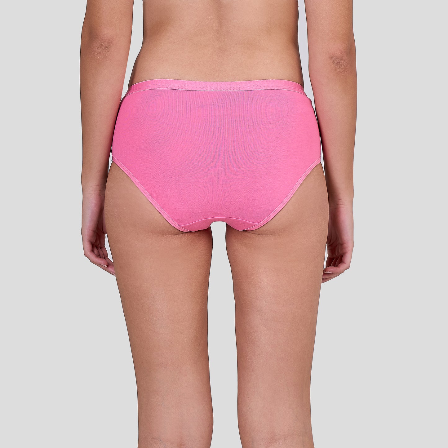 Person wearing Dice bright pink high-waisted underwear on a plain background