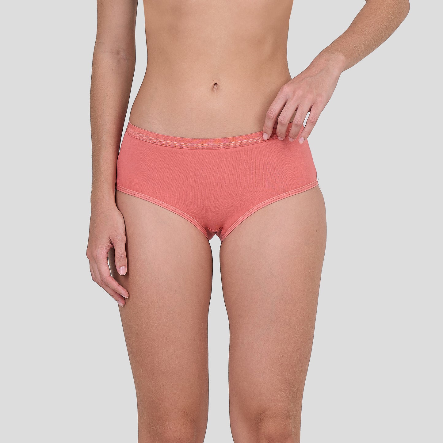 Person wearing a Dice coral pink underwear on a plain background