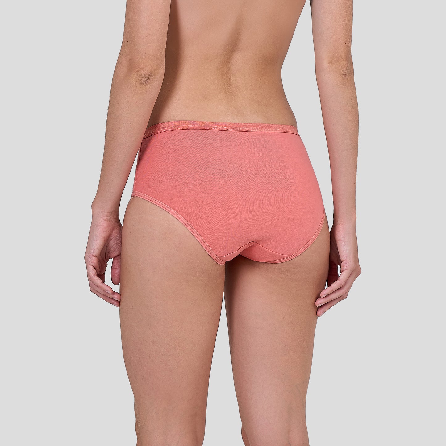 Dice Coral pink underwear worn by a person on a light gray background