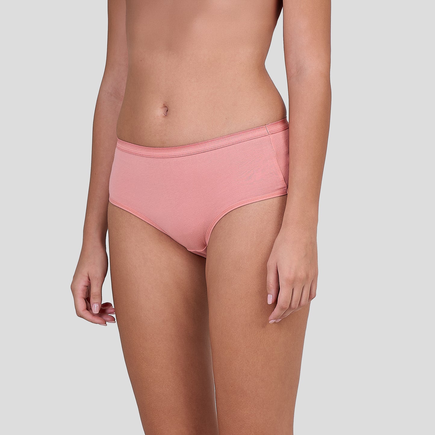 Person wearing a Dice pink bikini bottom on a light gray background