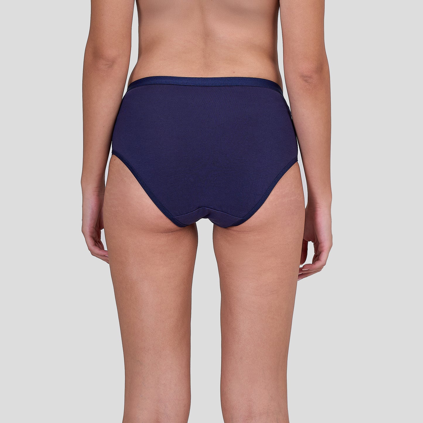 Dice Navy blue bikini bottom worn by a person on a light gray background