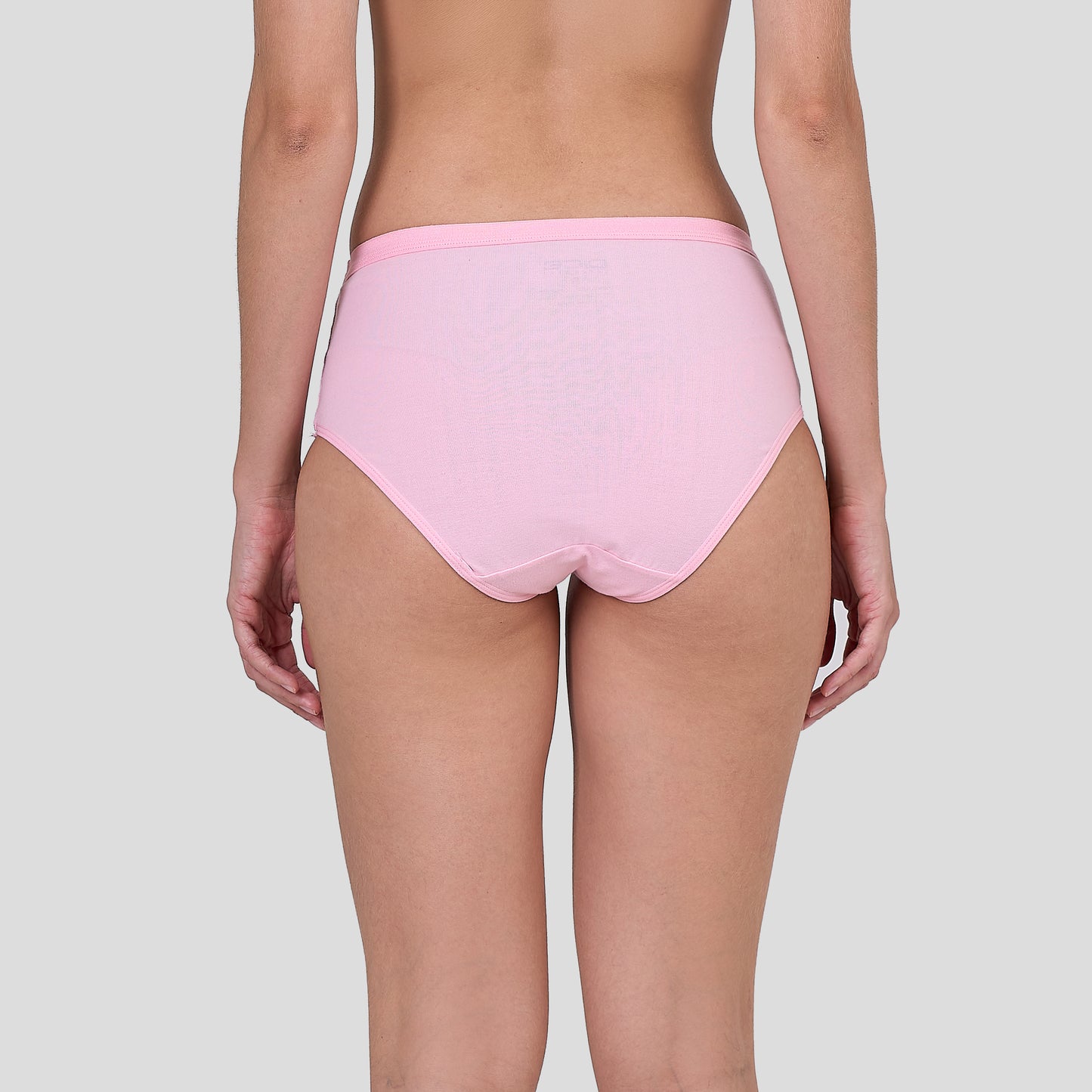 Person wearing a Dice pink high-waisted underwear on a plain background