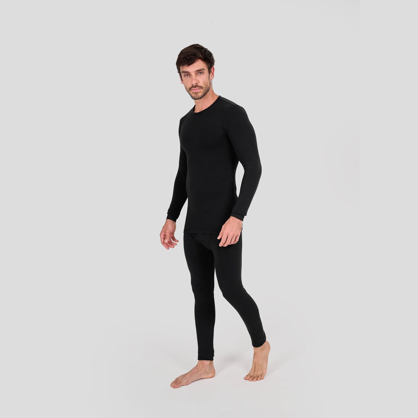 Man wearing a black thermal outfit on a light gray background