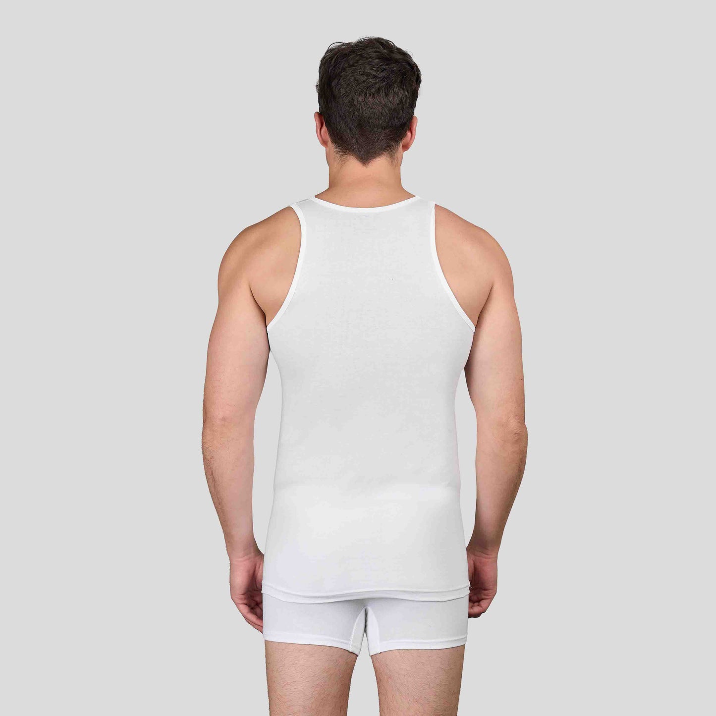 Man wearing Dice white tank top and underwear set on a plain background