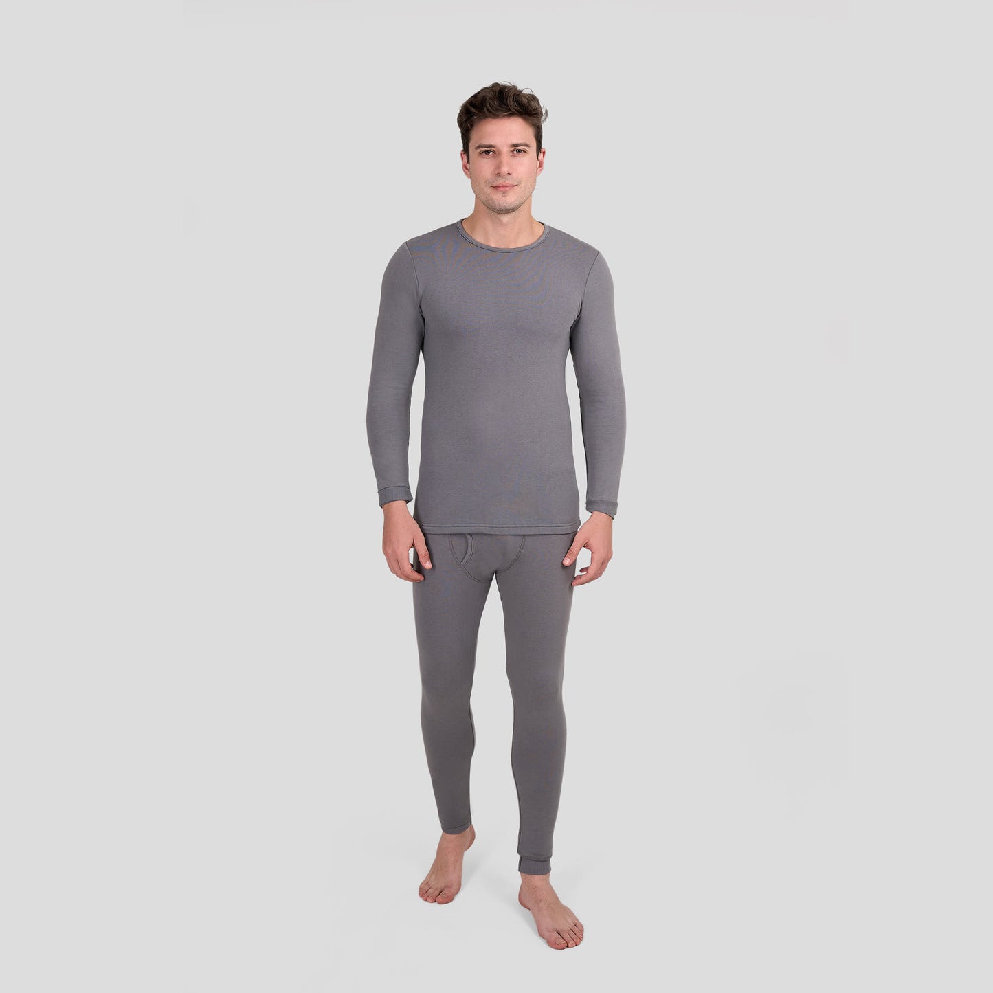 Man wearing gray thermal Dice underwear on a light gray background