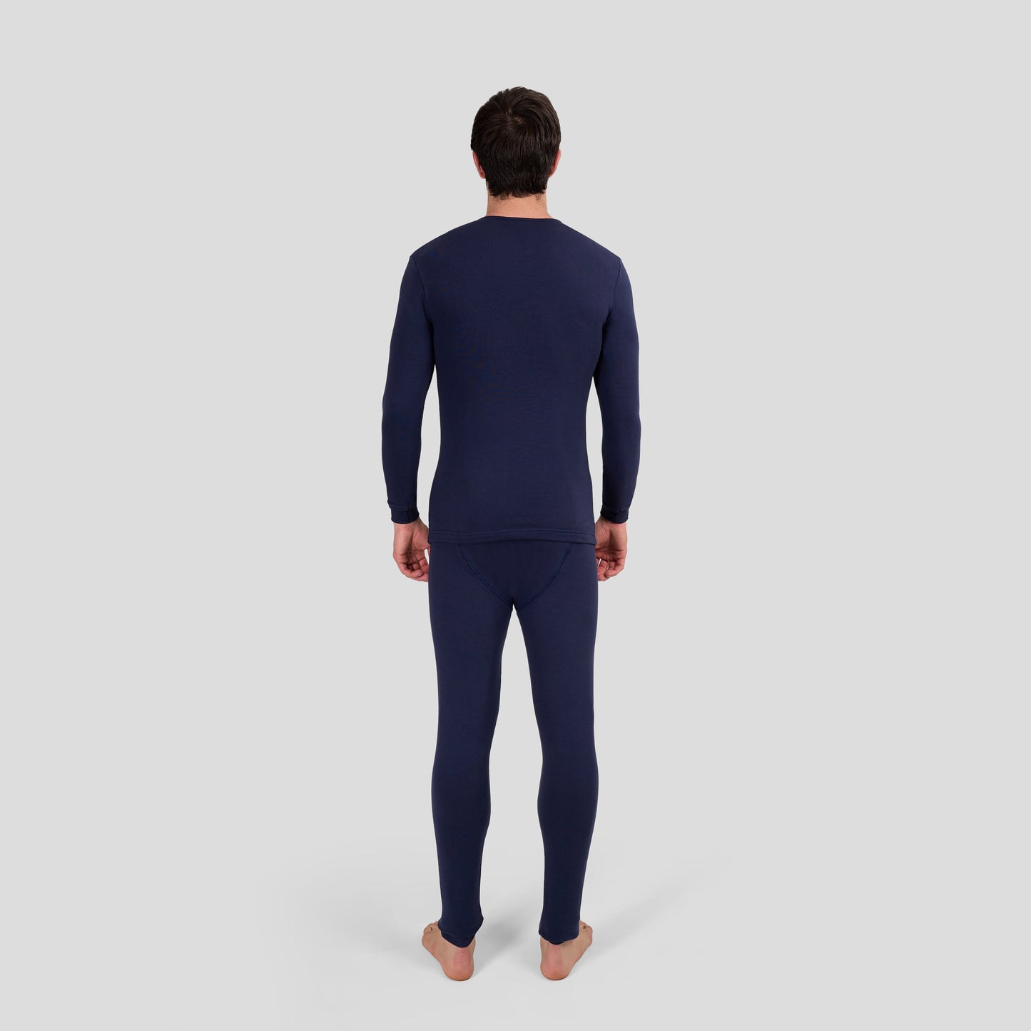 Man wearing Dice navy long-sleeve and long-bottomed thermal underwear set on a light gray background