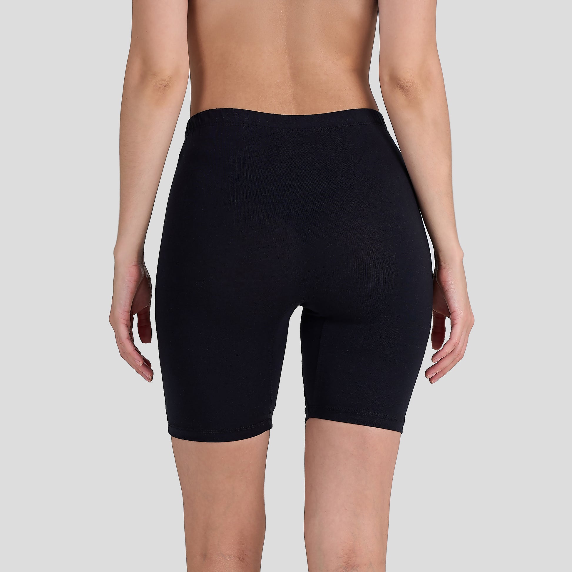 Person wearing a Dice black shorts on a plain background