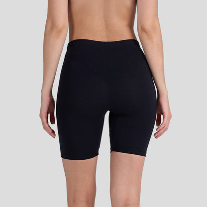 Person wearing a Dice black shorts on a plain background