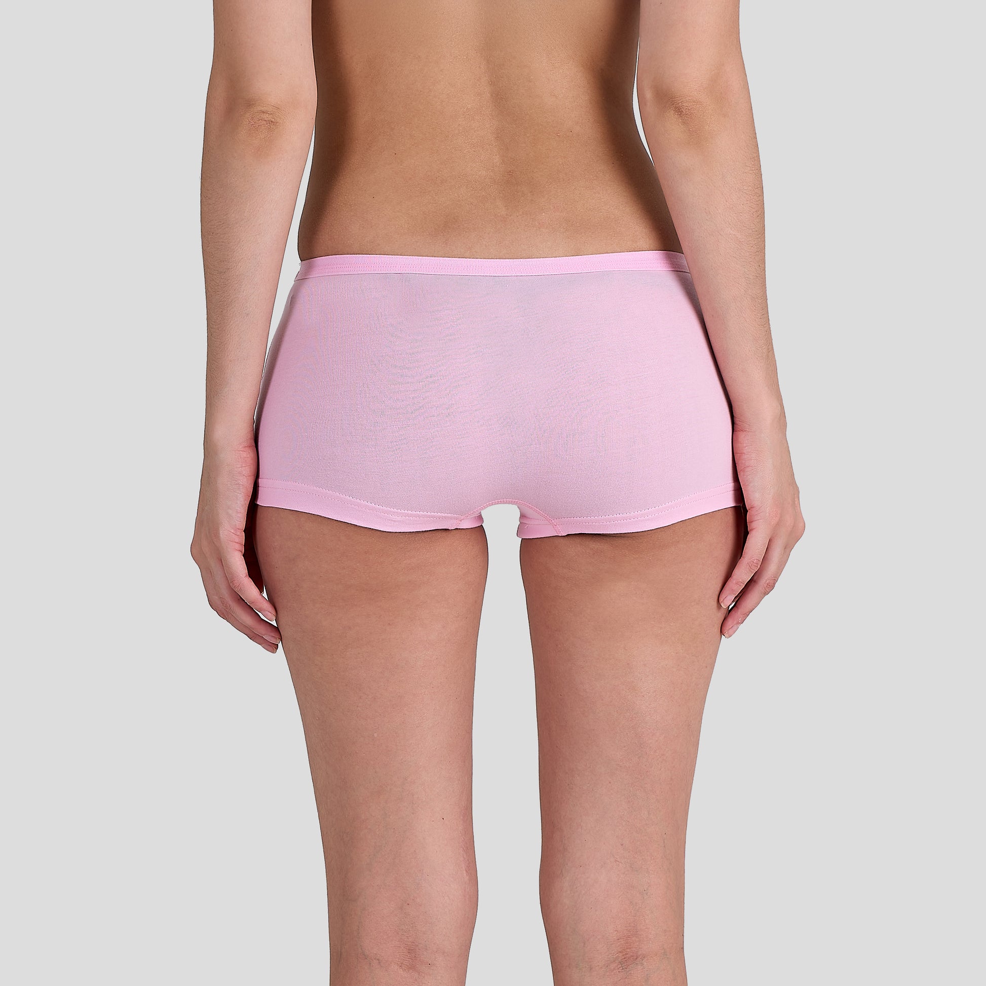 Women Dice wearing a pink underwear on a plain background