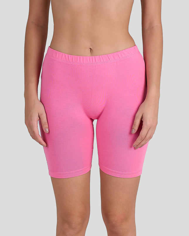 Person wearing Dice bright pink shorts on a gray background