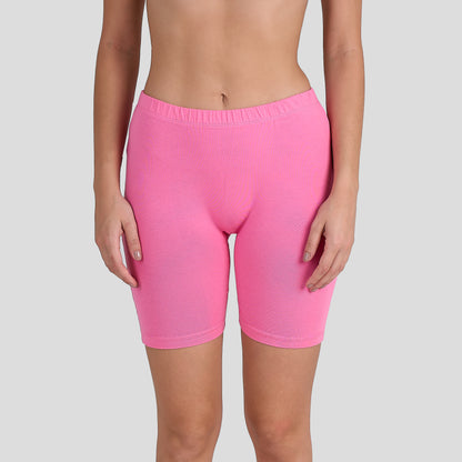 Person wearing Dice bright pink shorts on a gray background