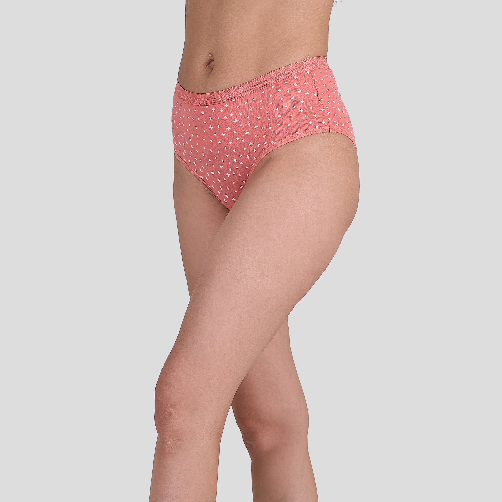 Person wearing a Dice pink polka dot underwear on a light gray background