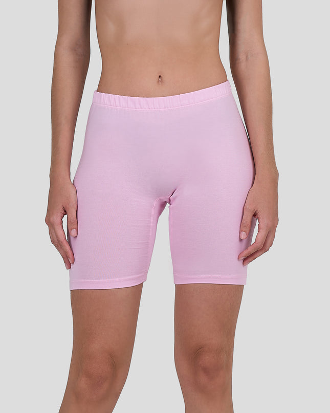 Person wearing a Dice light pink shorts on a plain background