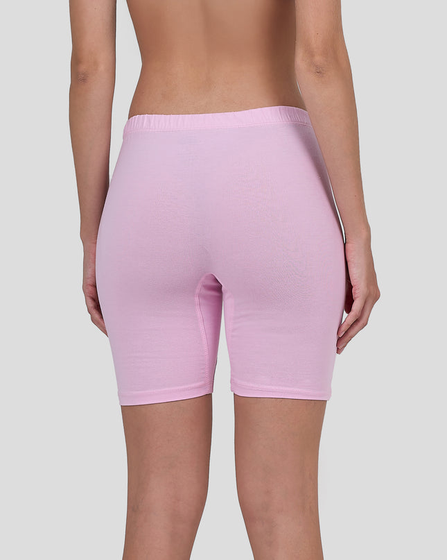 Person wearing a Dice light pink bike shorts on a plain background