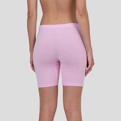 Person wearing a Dice light pink bike shorts on a plain background