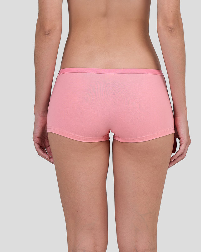 Person wearing a Dice pink shorts on a plain background