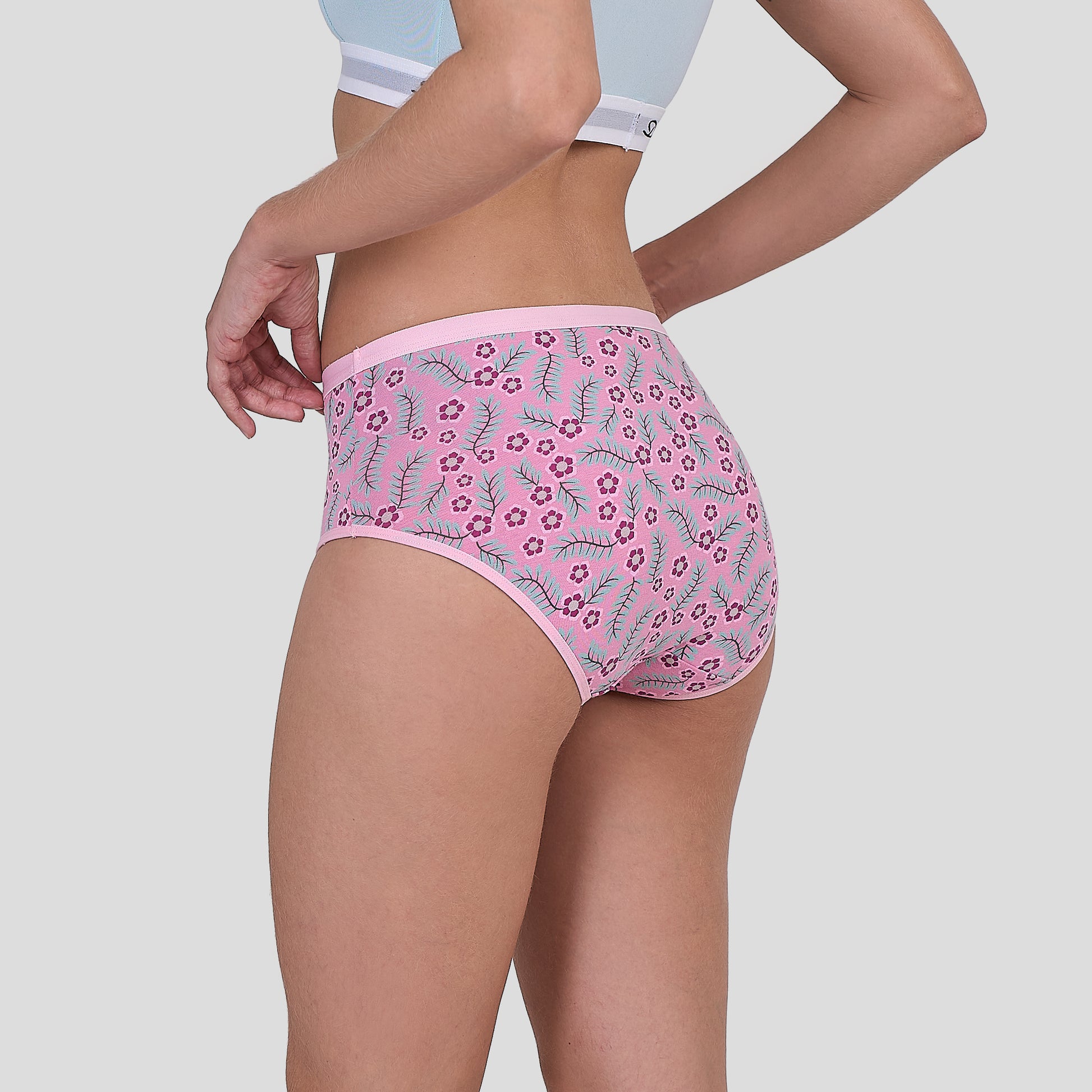 Person wearing a Dice pink floral underwear on a plain background