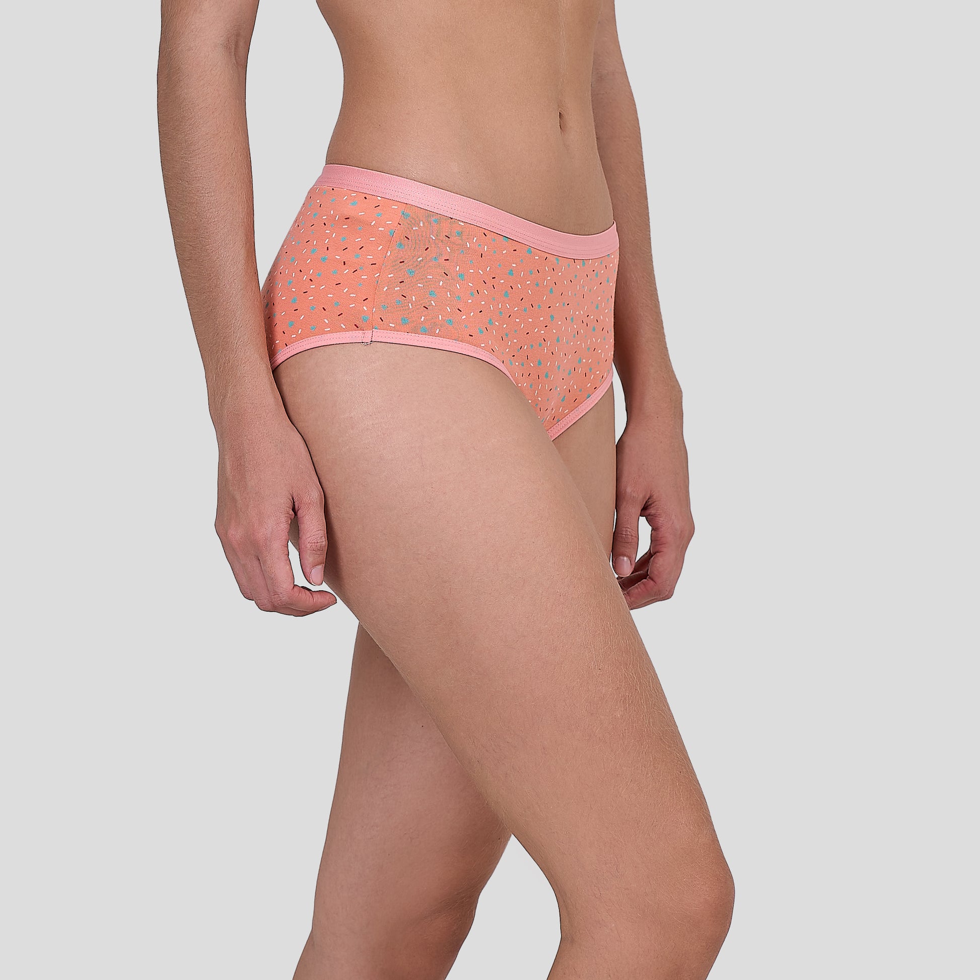 Person wearing a Dice patterned pink underwear on a plain background