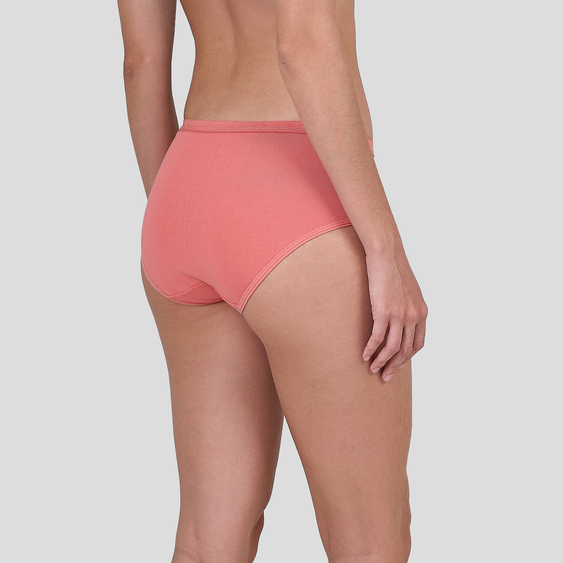 Person wearing a Dice coral pink high-waisted underwear on a light gray background
